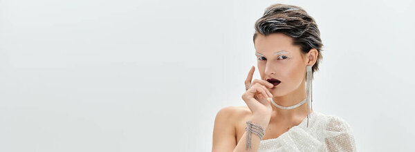 A graceful woman showcases her beauty in cozy, sophisticated winter attire, exuding elegance.