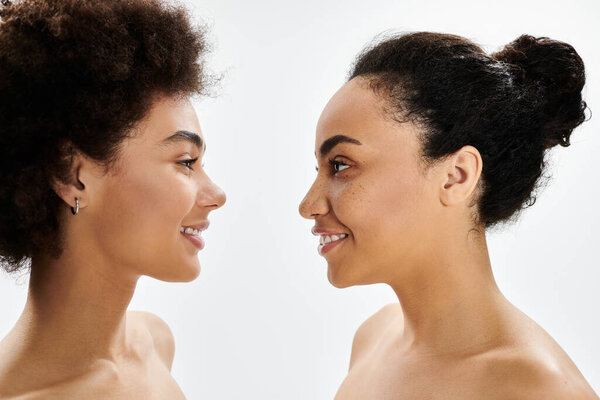 Two women face each other, highlighting their unique features and shared beauty traits.