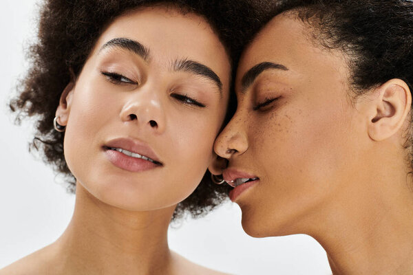 Capture of two women leaning close, exhibiting tenderness and artistic expression of friendship.