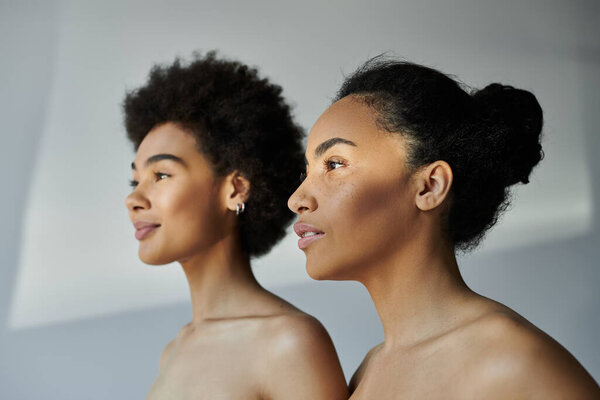 Two women stand side by side, embodying grace and tranquility under gentle natural light.