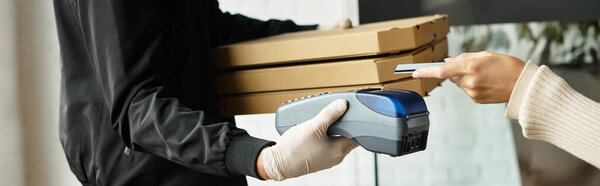 A delivery man is bringing food orders into an office building during lunchtime.