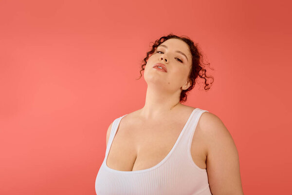 A radiant plus size woman stands gracefully, exuding confidence and charm in a stylish outfit.