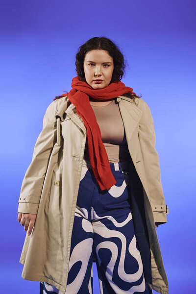 A confident plus size woman poses elegantly in a trendy outfit, radiating style and empowerment.