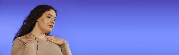 A beautiful plus size woman showcases her confidence and elegance with a gentle pose.