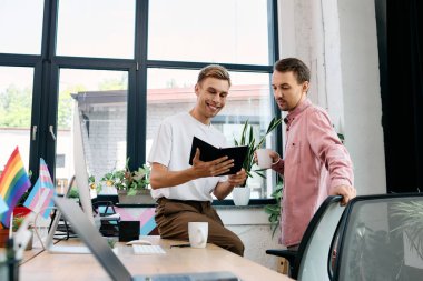 A cheerful couple discusses a project in a vibrant and welcoming workspace adorned with plants. clipart