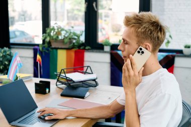 Talkative blonde man in casual attire working in office. clipart