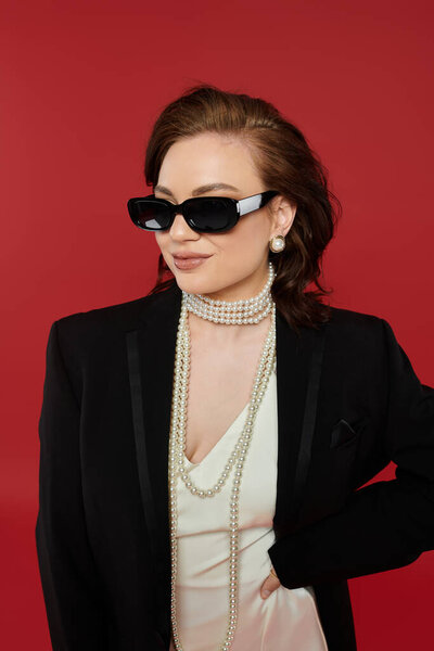 The beautiful young woman in a chic outfit showcases her elegance with striking accessories.