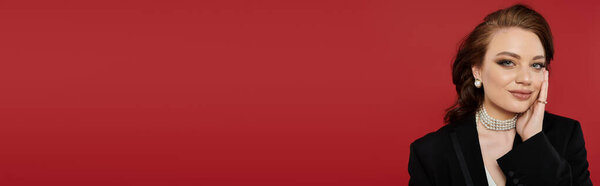 The elegant young woman radiates beauty while showcasing her sophisticated attire and charm.