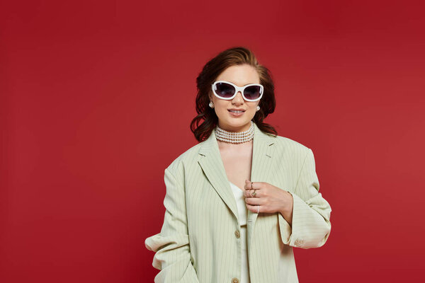 A stylish young woman radiates confidence, complementing her elegance with chic accessories.