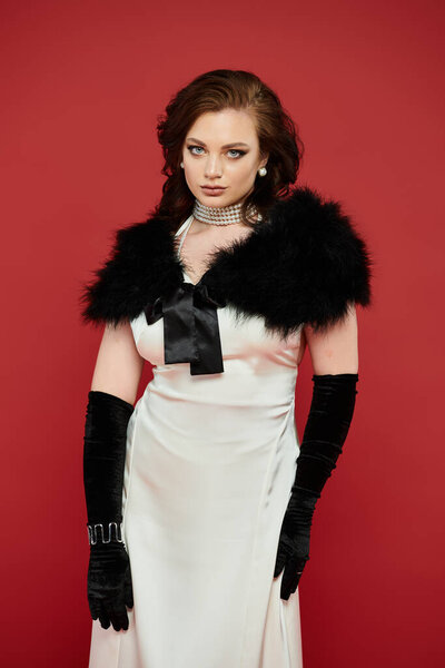 A beautiful young woman in a stunning outfit displays confidence and grace in a bold setting.