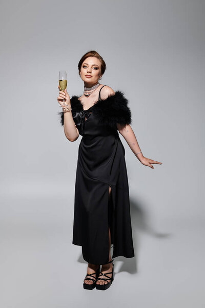 A stylish young woman in a glamorous outfit raises a glass, exuding confidence and elegance.