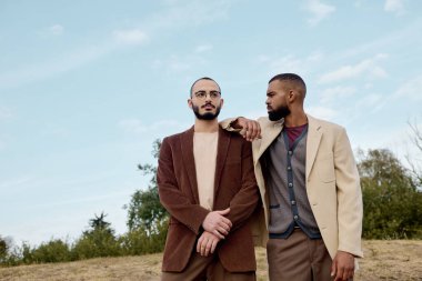 Two fashionable men celebrate the beauty of autumn, dressed in stylish outfits, amid a serene outdoor setting. clipart