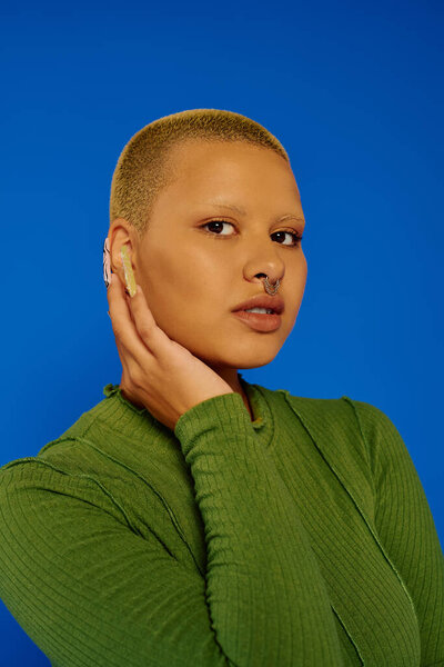 A fashionable young woman showcases her style with a bold expression and a striking background.