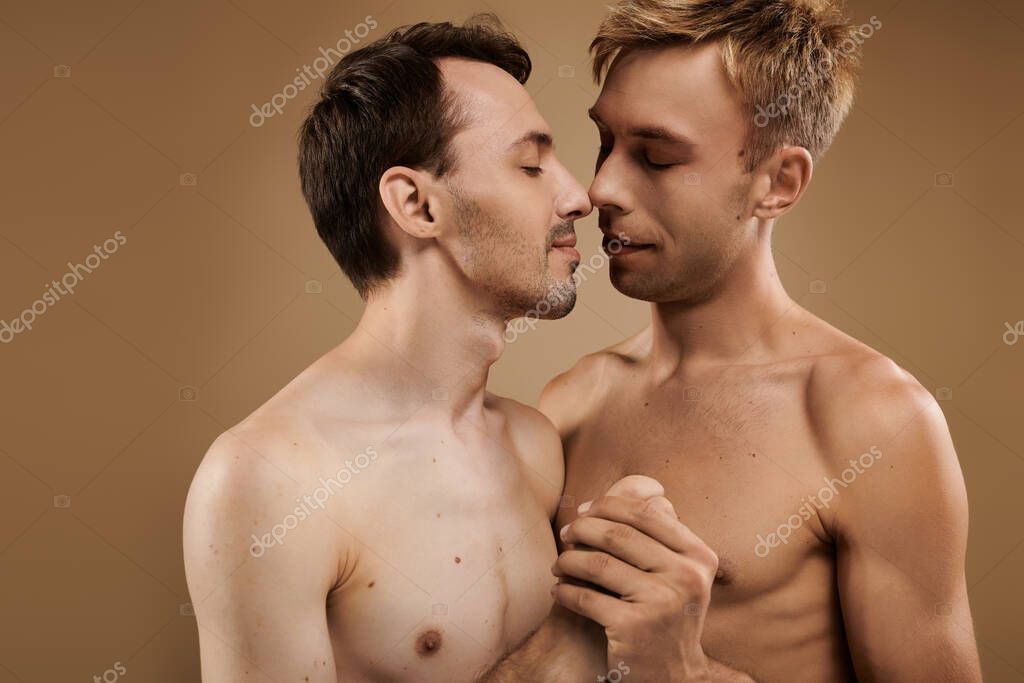 Two young men share a tender moment, embracing each other with affection and warmth.