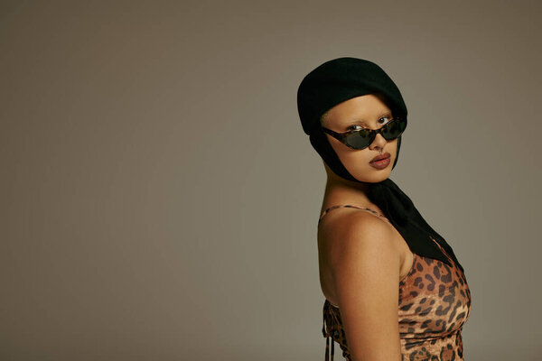 A young woman flaunts her unique fashion sense with elegance and poise.