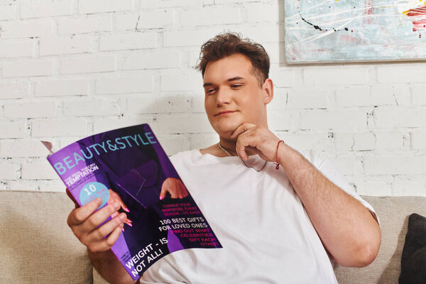 A unique person relaxes on a soft couch, flipping through a colorful lifestyle magazine.