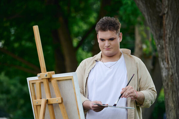 A person expresses their creativity while painting outdoors, surrounded by natures beauty.