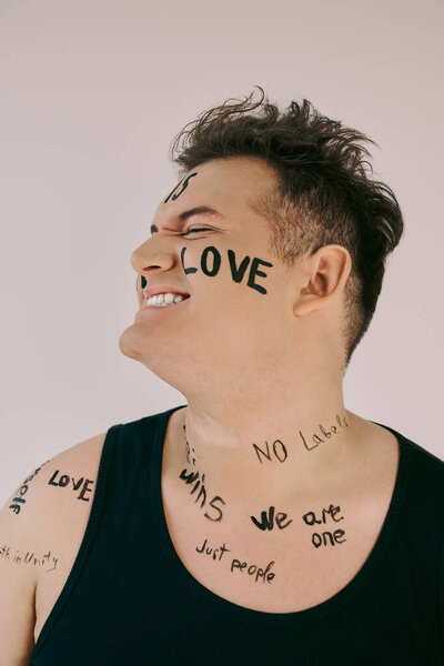 A queer person joyfully expresses identity with creative body art displaying love and unity.