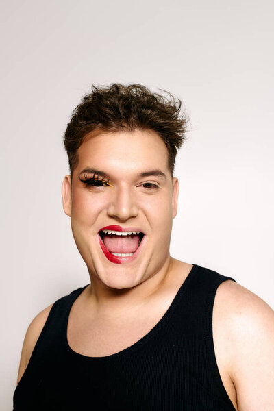 This spirited person radiates joy and self expression through striking makeup artistry and style.