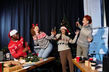 Cheerful coworkers gather to celebrate the holidays with festive drinks in the office. clipart