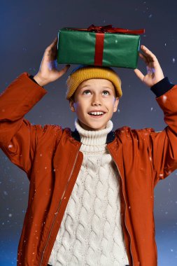 This cheerful boy, dressed warmly, delights in the joy of gift giving during winter festivities. clipart