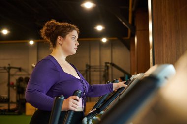 A person intensely exercises on a treadmill, showing dedication and focus. clipart