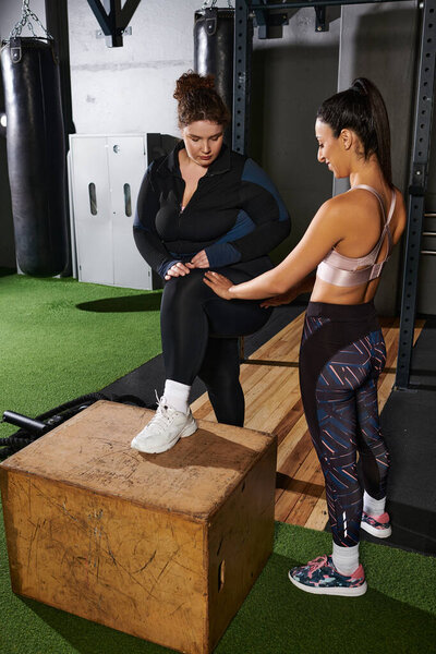 Two friends engage in a workout session at the gym, showcasing support and encouragement.
