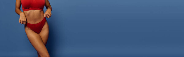 A confident African American woman poses in underwear, showcasing beauty and diversity.