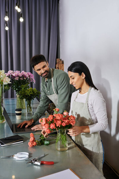 A married couple joyfully crafts stunning floral designs in their small shop.