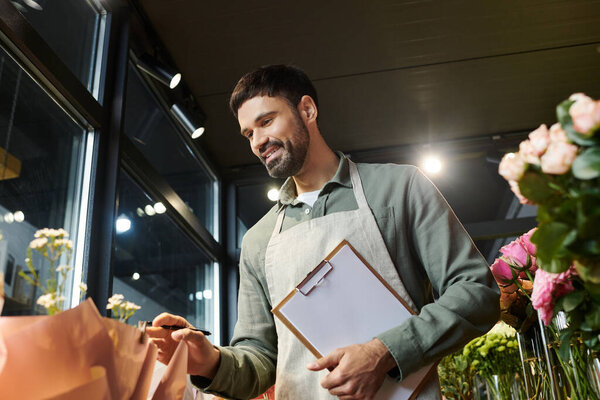 A skilled bearded man curates beautiful flowers in his vibrant shop, showcasing his talent.
