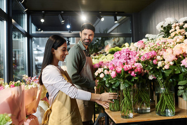 Owners of a florist shop are busy preparing beautiful floral arrangements side by side.