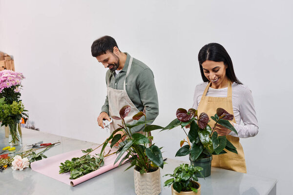 A dedicated florists engage with work, creating floral arrangements together.