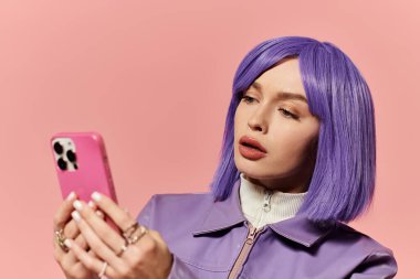 A vibrant woman with purple hair is focused on her smartphone in a colorful indoor space. clipart