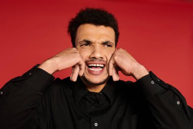 A young and attractive man displays a range of emotions against a bold red backdrop. clipart