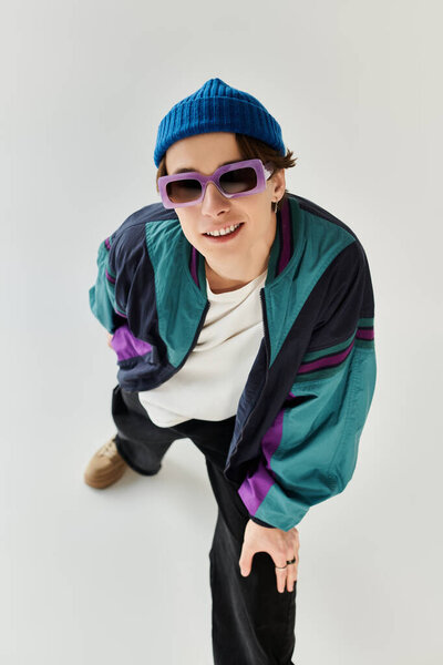 A stylish young man sports a bomber jacket and sunglasses, reflecting youth culture.