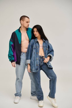 Şık giyinmiş genç bir çift modern bir stüdyoda aşk ve moda sergiliyor..