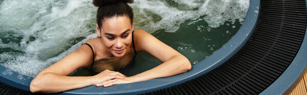 A young woman relaxes in a spa hot tub, embracing serenity and self care amidst bubbles.