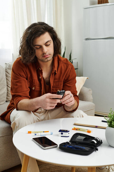 A young man with diabetes checks his blood sugar while relaxing in his stylish apartment.