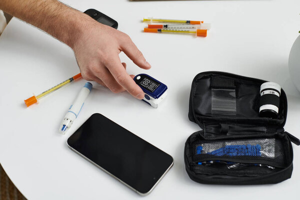 Young man checks blood sugar levels while maintaining his diabetes routine at home.