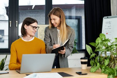İki genç, şık bir ofis ortamında fikirleri tartışıyor..