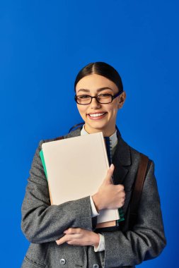 A young woman in glasses smiles brightly as she hugs her folders, adding to the lively vibe. clipart