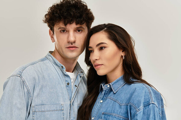 Молодые люди выражают уверенность в совпадении джинсовых нарядов, представляя шикарные вибрации.