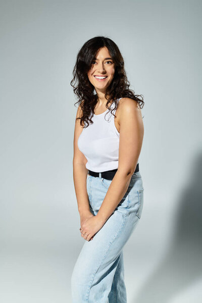 Radiating confidence, a young plus size woman shines in a studio setting.