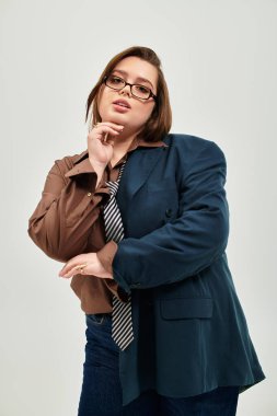 Ayrıca cüsseli kadın kendine güvenen bir şekilde poz veriyor. Kişisel tarzını ve çekiciliğini ifade ediyor..