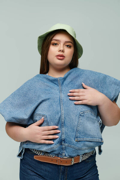 A young and beautiful plus size woman poses with poise, displaying her unique style and confidence.