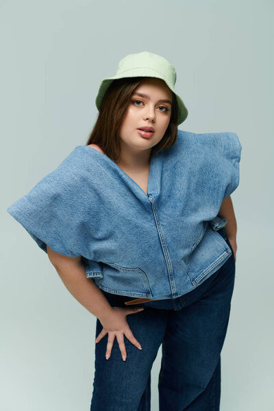 A beautiful young woman showcases her confidence in a fashionable outfit with a playful hat.