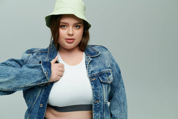 Plus size woman showcases her unique style with confidence in a comfy outfit and trendy hat.