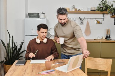 Two brothers engage in a creative activity at a cozy kitchen table, surrounded by homey decor. clipart