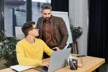 A new professional gets advice from a mentor on their first day at the office. clipart