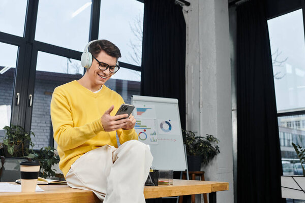 New employee enjoys a productive first day while interacting with a smartphone in the office.